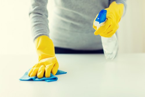 Local oven cleaner working in a compact Highbury flat kitchen