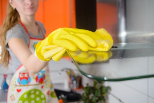 Cleaning kitchen and bathroom areas in a Highbury short-let property